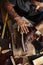 Close up of shoe maker hands producing boots in his leather workshop