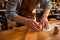 Close up of a shoemaker cutting leather