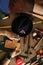 Close up of a shoemaker working with leather sample and hammer at workshop