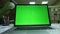 Close-up shooting of green screen of the office copture which is lying on the desk, empty office