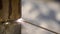 Close-up shooting of a professional welder welding a gas pipe outdoor.