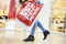 Close Up Of Shopper\'s Feet Carrying Bags In Shopping Mall