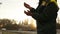 Close up shot of adult farmer man hands holding wheat grain in warm sunset light. Grain sifts through fingers