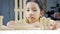 Close up shot Asian little girl playing wooden brick toy