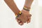 Close up shot of Asian Male couple holding hands with  gay pride rainbow awareness wristbands. LGBT, same-sex love and homosexual