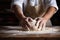 close-up shot of a baker kneading dough on a wooden surface