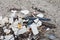 A close up shot of the beach that is dirty with sea garbage