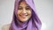 Close up shot of beautiful muslim lady wearing hijab, looking at camera and smiling