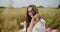 Close-up shot of a beautiful woman relaxing during picnic at the wheat field