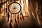 A close-up shot of a beautifully adorned dream catcher hanging in a softly lit room, casting intricate shadows on the wall