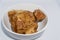 A close up shot of a bowl of Jaggery. It is a concentrated product of cane juice & often date or palm sap without separation of