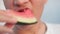 Close up shot of boy Caucasian eating triangular watermelon.