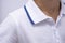 close-up shot with a boy in white polo with a blue stripe. fragment of photo of child in suit on a white background