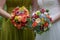 Close-up shot of bride and bridesmaid holding large colorful and sophisticated wedding bouquets