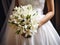 Close up shot of bride holding a bouquet of lilies