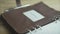 Close up shot of brown leather note pad book business project daily planner bullet journal habit tracker on wooden table