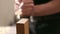 Close up shot of carpenter or joiner working with hand planer in wood workshop