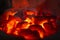 Close-up shot of charcoal burning glows in a stove