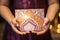 A close-up shot of a child\\\'s hands holding a beautifully decorated Eid mubarak idul adha greeting card