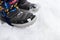 Close up shot of childrens snow boots. Winter footware. Boy standing in snow, shoes detail.