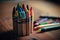 A close-up shot of colourful crayons on a wooden table with paper