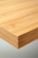 Close up shot of corner of wooden table with visible texture. Home interior decoration natural materials