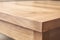 Close up shot of corner of wooden table with visible texture. Home interior decoration natural materials