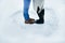 Close-up shot of the couple legs standing in the middle of the heart of snow.