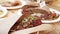 Close-up shot of delicious pastrami meat pieces with green onions on table.