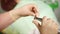 Close up shot of the dentist`s hands who changes the nozzle in dental instrument