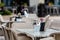 Close up shot of empty cafeteria or restaurant tables with chairs on street