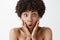 Close-up shot of excited and amazed stunned cute naked african american woman with curly hair loosing speech from