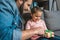 close-up shot of father presenting gift for daughter while sitting