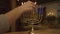 Close up shot of female hand lighting candles on menorah during Hanukkah celebration. High quality