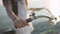 Close up shot of female hands on a bicycle handlebars. Attractive young woman on the sea at sunset or sunrise