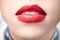 Close-up shot of female lips with red lipstick