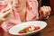 Close-up shot of female portrait eating a spoon of ice cream from scoop at plate. dessert menu in restaurant.