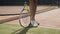 Close up shot of female tennis player spining racket on the ground.