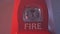 Close up shot of flashing strobe red fire alarm during fire in the room