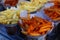 Close-up shot of french fries sprinkled with paprika powder, food sold at a street food market