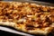close-up shot of a freshly baked chicken shawarma flatbread, with crispy edges and a soft center, topped with sesame seeds