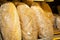 Close-up shot of freshly baked delicious loaves of bread at a market for sale