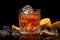 Close-up shot of a freshly poured Sazerac cocktail on table with lemon. Dark background.