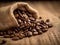 Close-up shot of freshly roasted coffee beans in a rustic burlap sack