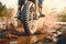 Close-up shot of the front wheel of a motocross bike riding along a muddy dirt track