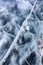 Close up shot of frozen waters with included of cracks, bubbles and herbs of baikal lake ice