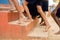 close up shot, group of school kids legs in barefoot climbing steps to go school - concpet of poverty, education