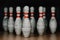 close-up shot of grungy bowling pins in gate on black
