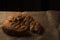 Close up shot of a hand divided Ramadan pita bread on a jute background