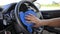 Close up shot hand of man using blue micro fiber fabric to clean steering wheel